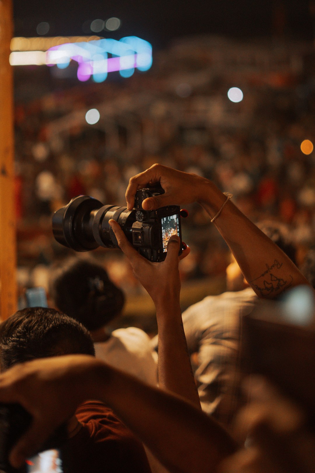 gallery-5 person-holding-camera-at-a-crowded-event-26wtd5v33c8