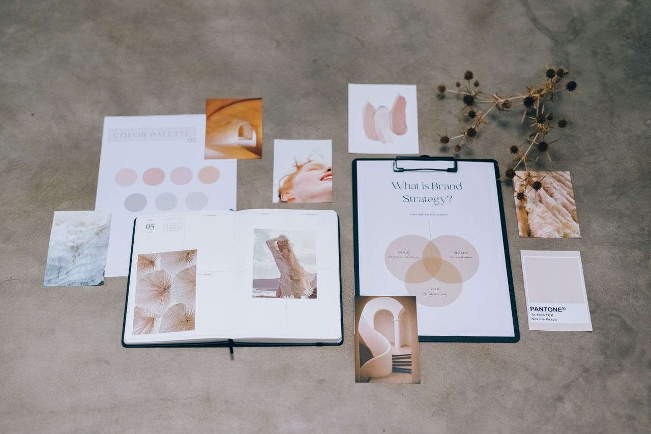 töitämme A flat lay of branding elements with color palettes and strategic planning documents on a concrete surface.